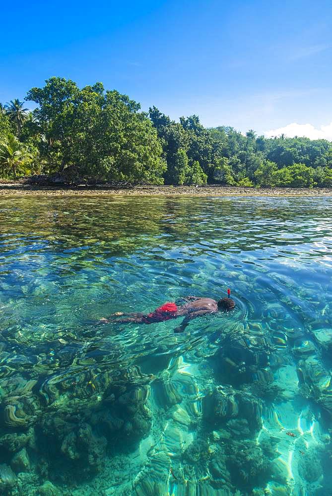 Man snorkeling in the clear waters, Buka, Papua New Guinea, Oceania