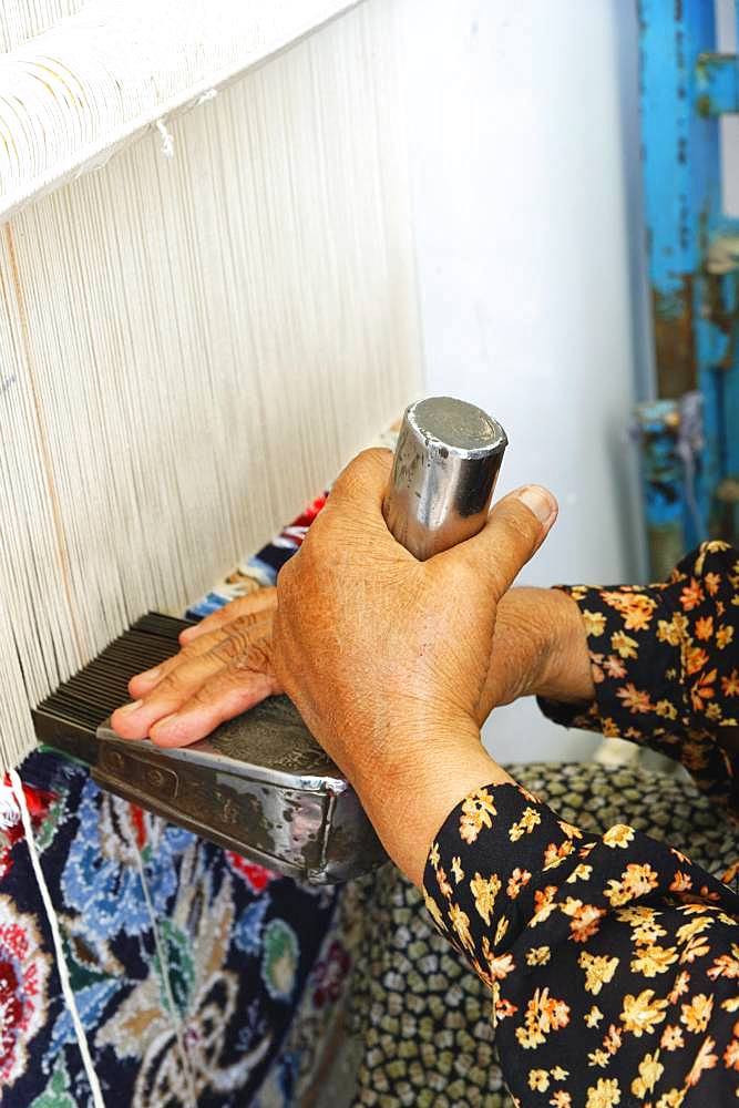 Iranian woman weaving a carpet, Na'in, Isfahan Province, Iran, Asia