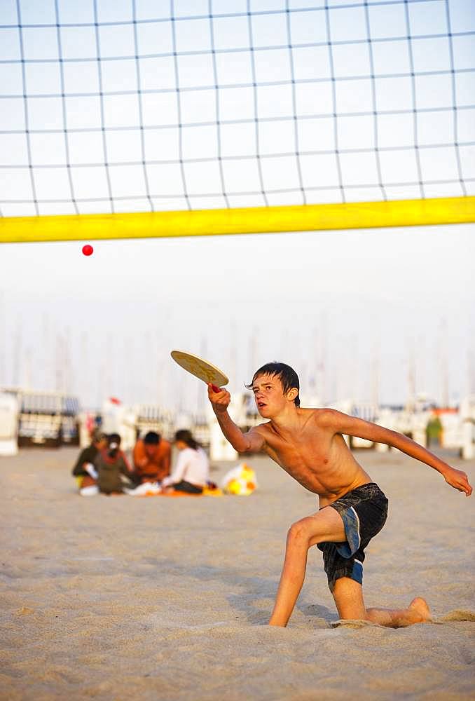 Youth playing beach tennis at the Baltic Sea beach, Kuehlungsborn, Mecklenburg-Vorpommern, Germany, Europe