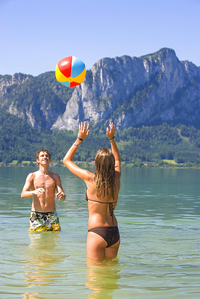 Two teenagers play with water polo in a lake, 18 years, Mondsee, Upper Austria, Austria, Europe