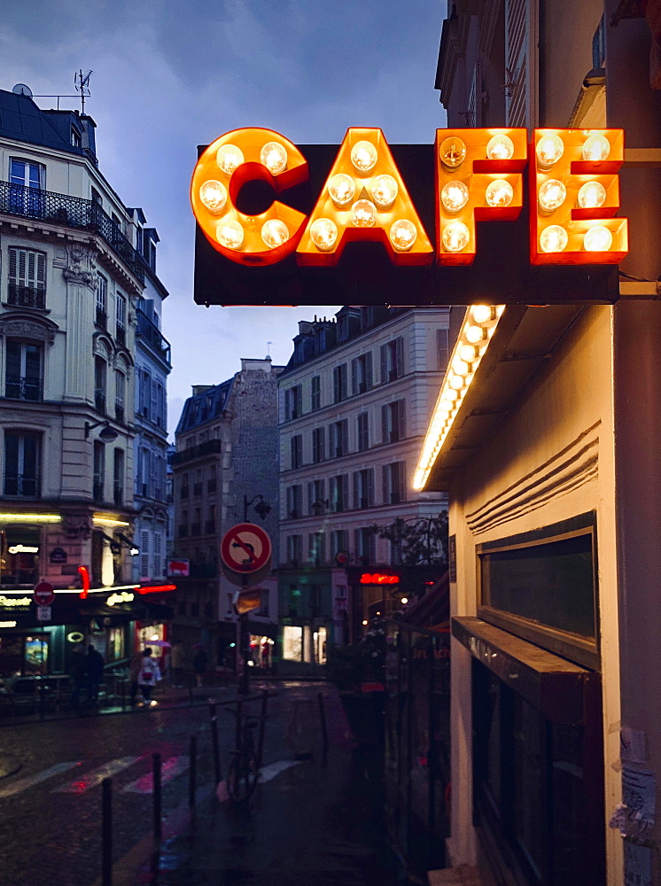 Illuminated advertising for a cafe, dusk, Montmartre, Paris, France, Europe