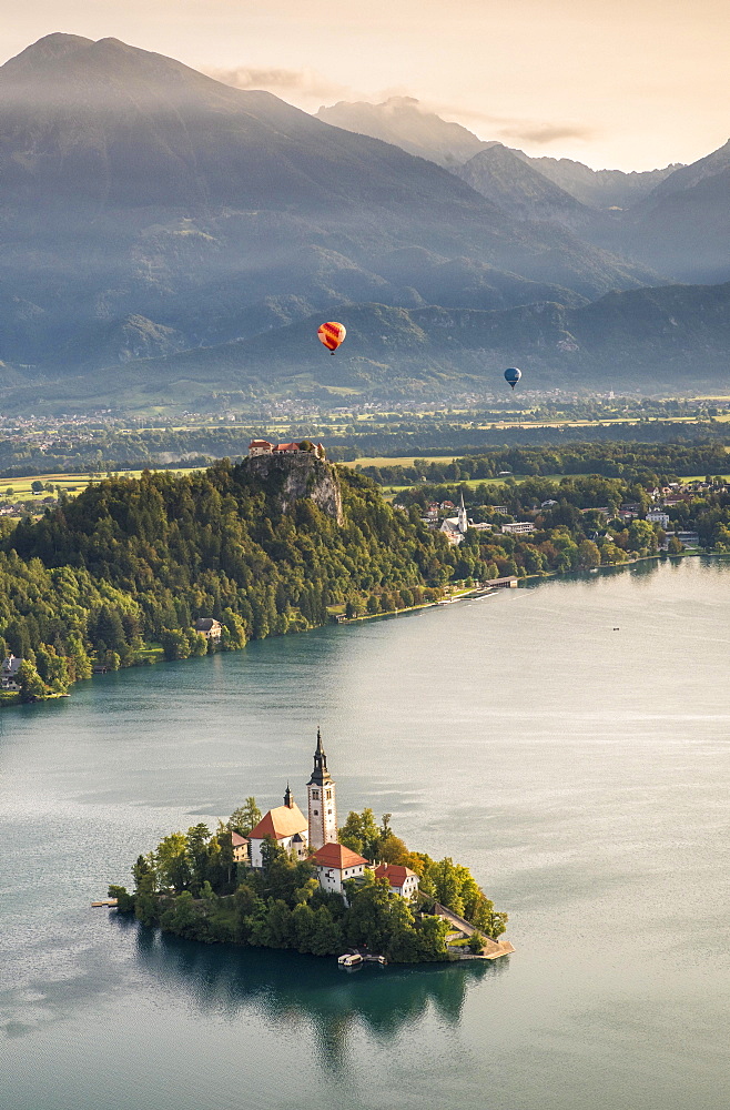 Lake Bled with Bled Castle and Blejski Otok Island with St. Mary's Church, behind it Karavanke, Bled, Slovenia, Europe