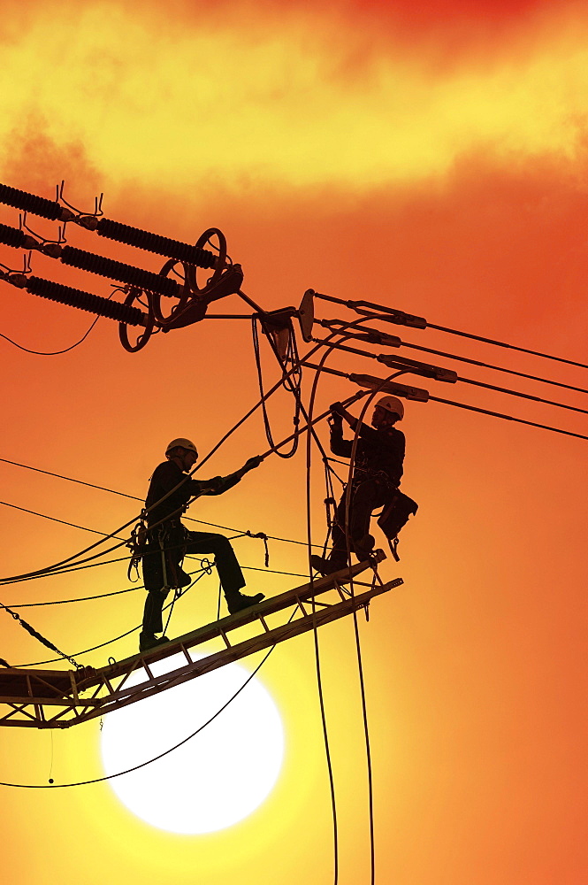 Digital Composing, High voltage engineers working on high voltage pylons, Baden-Wuerttemberg, Germany, Europe