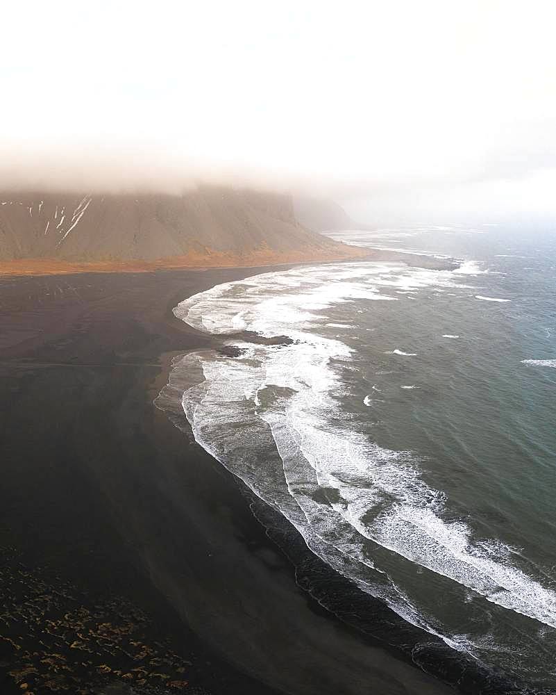 Stokksnes Beach from the air with clouds, lava sand beach, Vestrahorn, Iceland, Europe