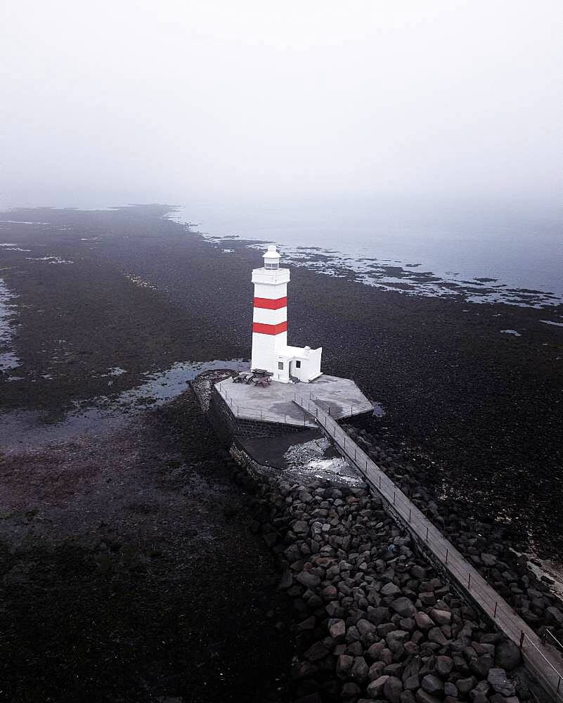 Aerial view, red and white lighthouse Garour Old Lighthouse, black lava beach, Iceland, Europe