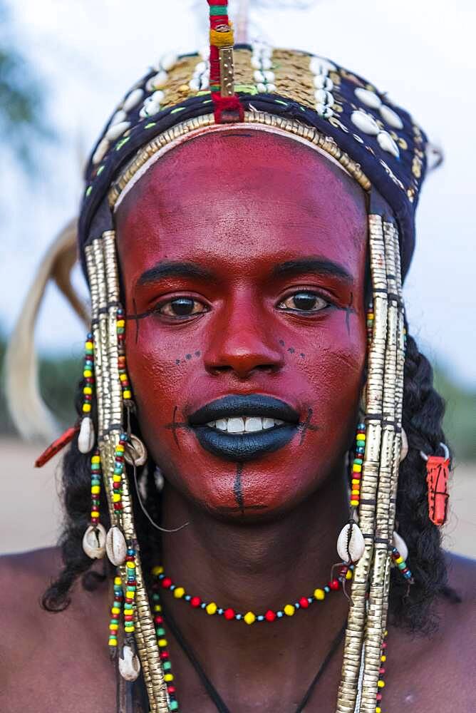 Wodaabe-Bororo man with face painted at the annual Gerewol festival, courtship ritual competition among the Fulani ethnic group, Niger, Africa