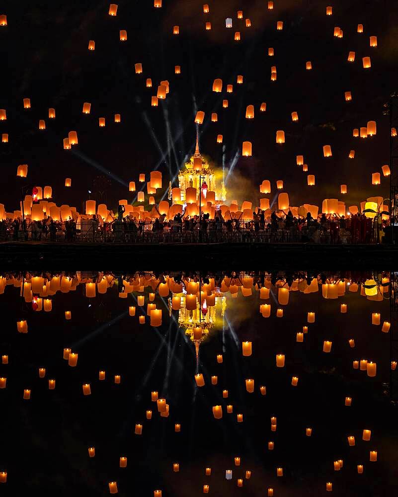 Yi Peng Festival with rising lanterns and a reflection in the lake, Chiang Mai, Thailand, Asia