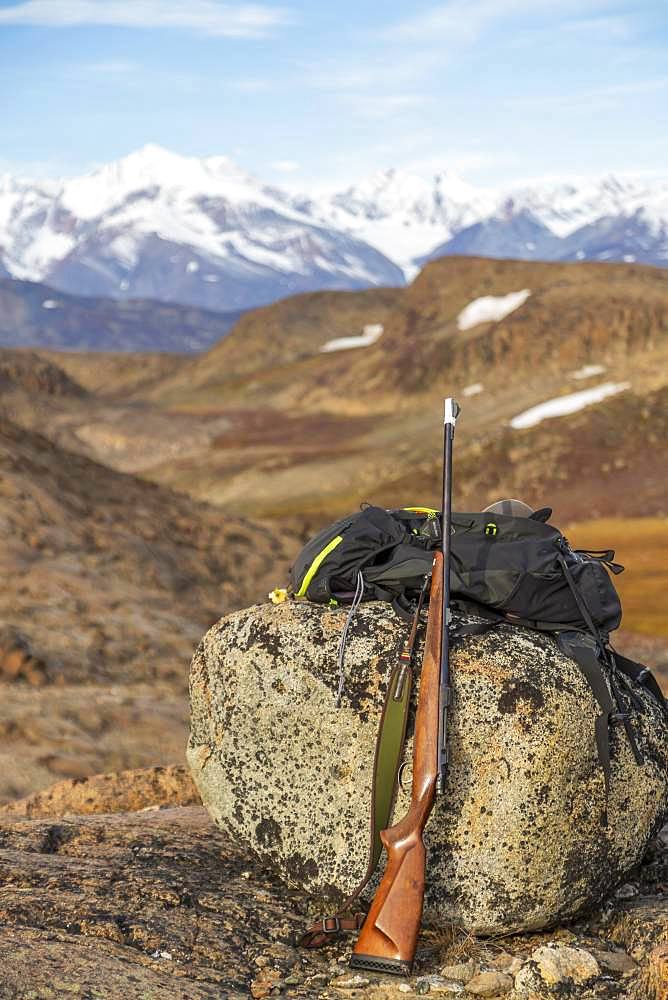 Rifle leaning against rock, barren landscape, protection from polar bears, east coast Greenland, Denmark, Europe