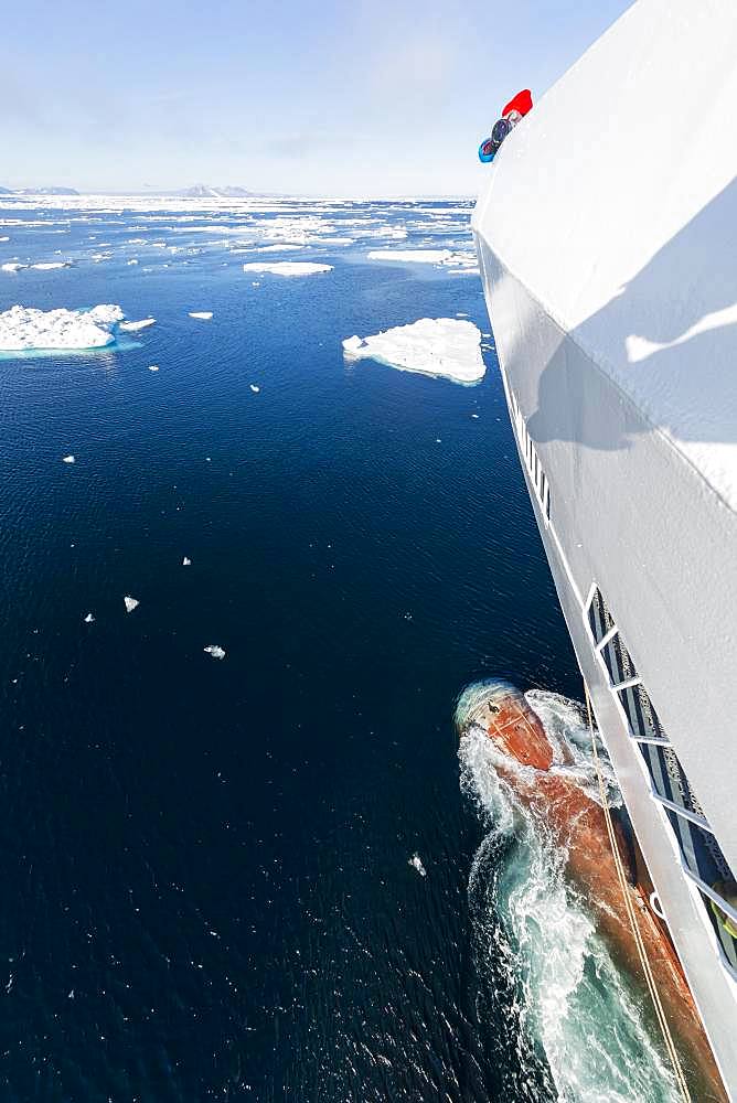 Passengers on deck of a cruise ship, bowsprit, icebergs, sea, east coast Greenland, Denmark, Europe