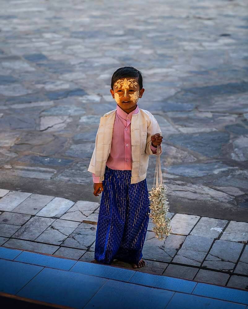 Small boy with yellow face painting, sandalwood, in the Kuthodaw Pagoda, Mandalay, Myanmar, Asia