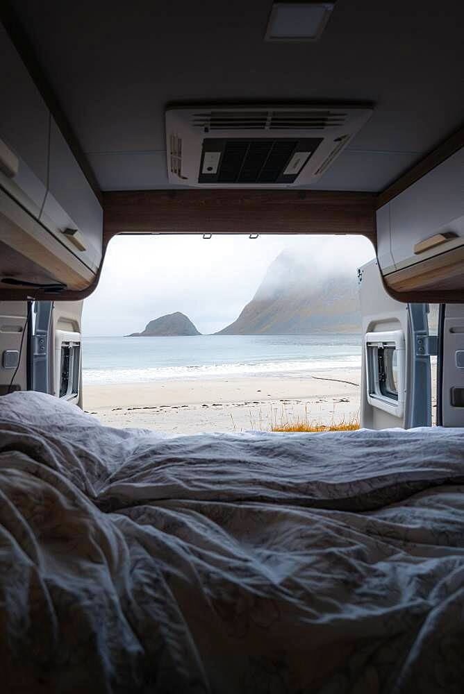 View from the rear of the campervan to beach with turquoise water, Haukland beach, Lofoten, Norway, Europe