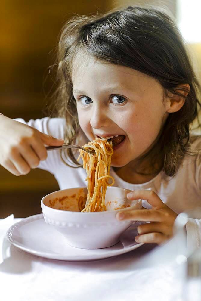 Girl eating spaghetti