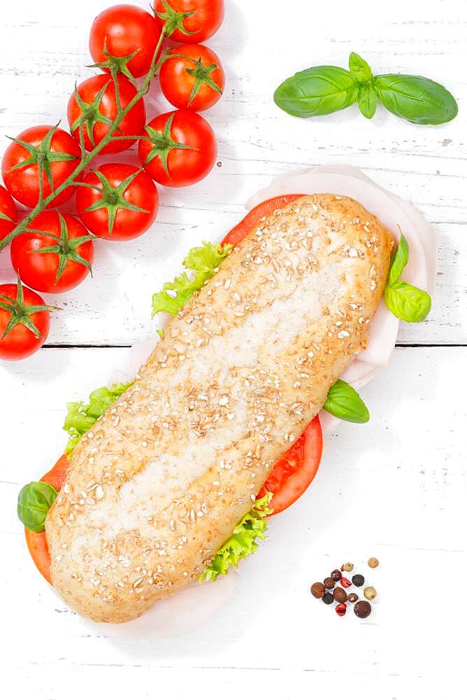 Sandwich baguette wholemeal roll topped with ham from the top on