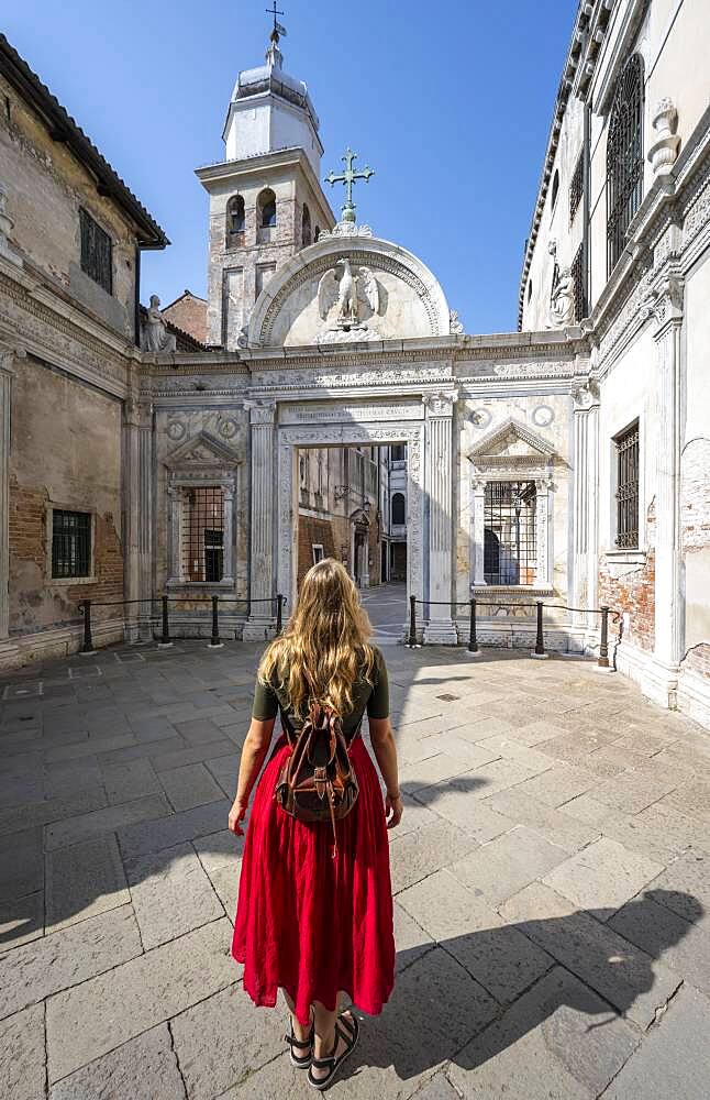 Young woman in front of church San Giovanni Evangelista, Venice, Veneto, Italy, Europe