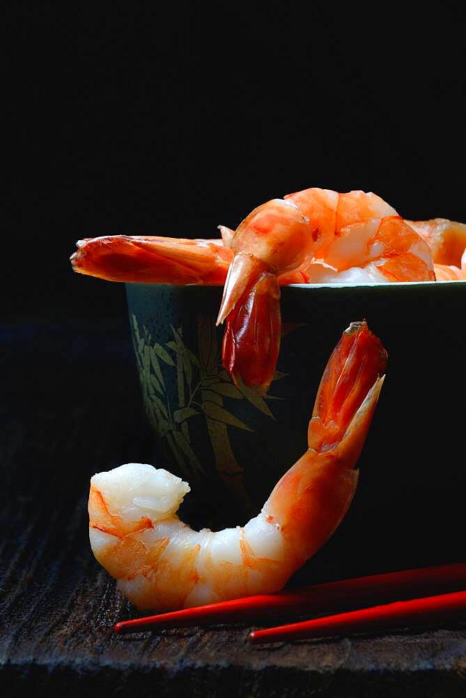 Cooked prawns in shell with chopsticks, Germany, Europe