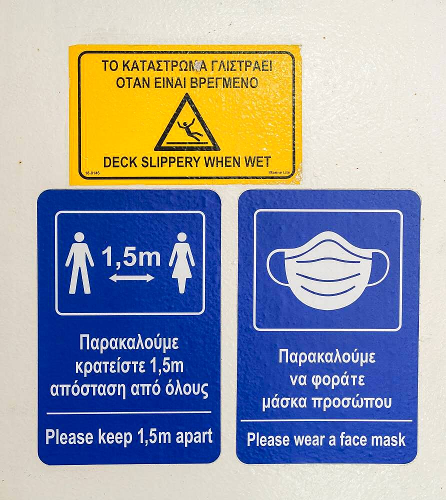 Warning and information signs on a Greek ferry, distance regulations during Corona, Covid-19 in Greece on a ferry, Greece, Europe