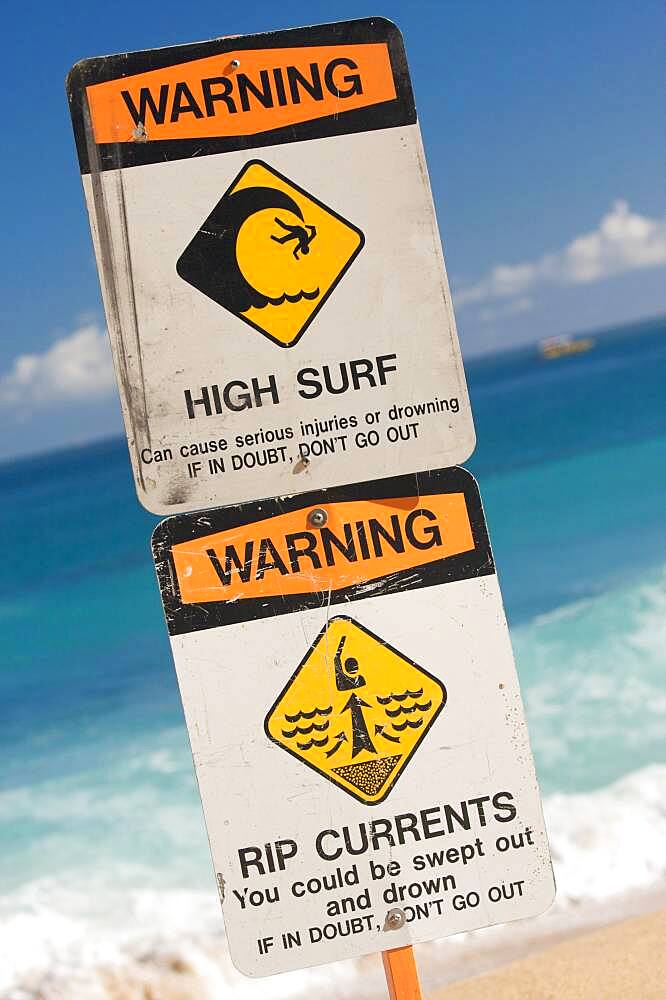 Surf and currents warning sign on a beach in hawaii