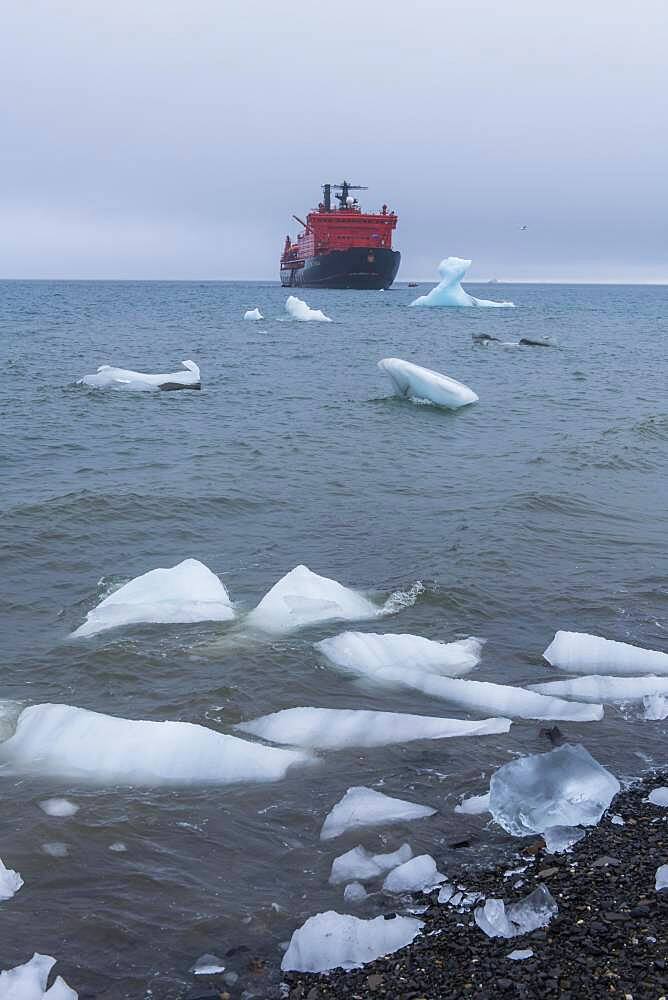 Icebreaker anchoring behind a iceberg, Champ Island, Franz Josef Land archipelago, Russia, Europe