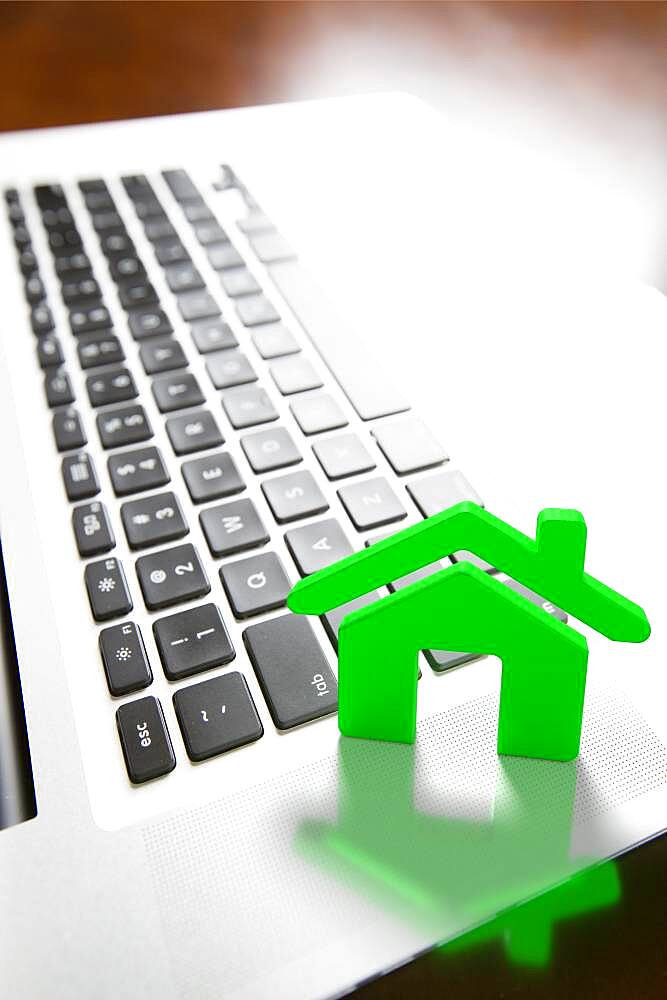 House icon resting on laptop keyboard