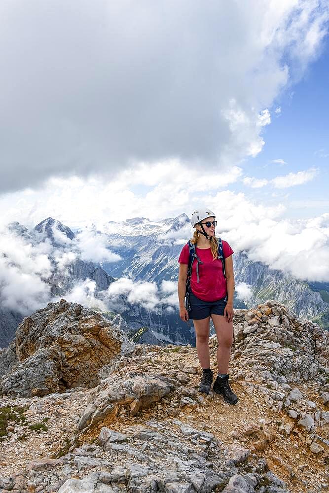 Hiker on the via ferrata to the Patenkirchner Dreitorspitze, Wetterstein Mountains, Garmisch-Partenkirchen, Bavaria, Germany, Europe