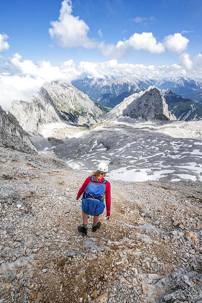 Hiker on the via ferrata to the Patenkirchner Dreitorspitze, Wetterstein Mountains, Garmisch-Partenkirchen, Bavaria, Germany, Europe