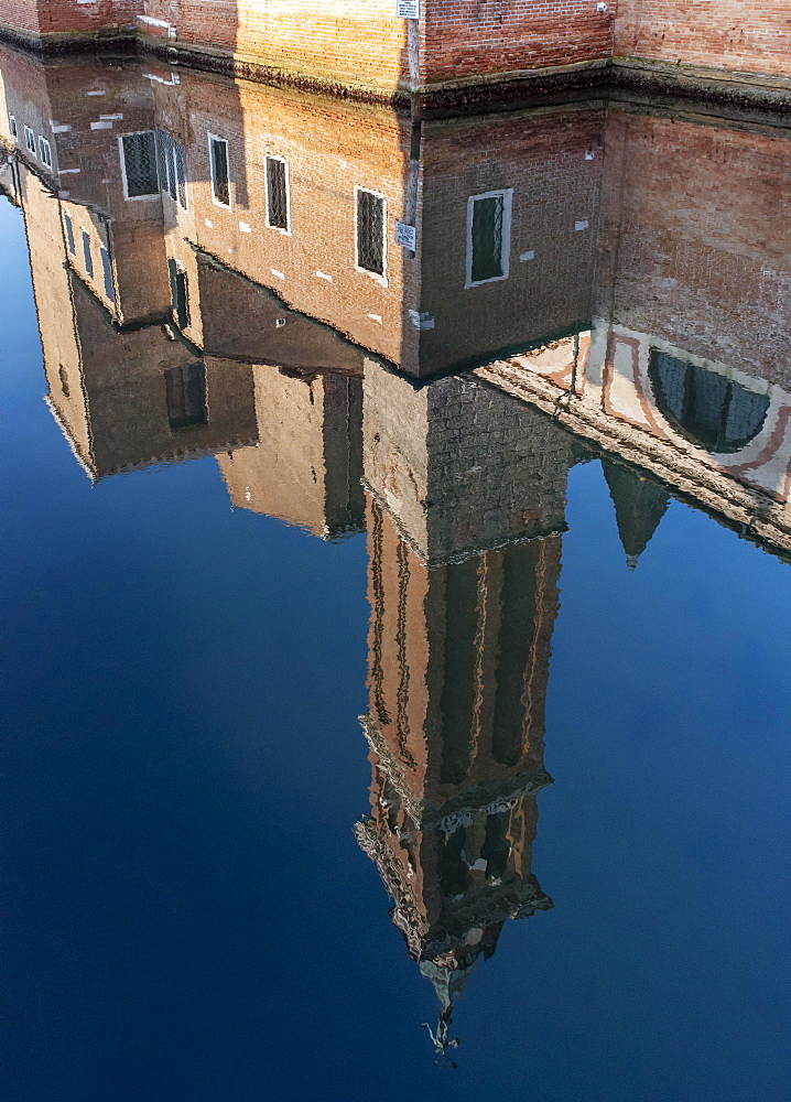 Bell-tower of Church of St. James Apostle -San Giacomo Apostolo, reflected in Canal Vena, Chioggia, Venice, Italy, Europe