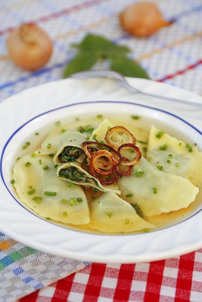 Swabian cuisine, Maultaschen in broth with stewed onion rings and chives, soup plate, Germany, Europe