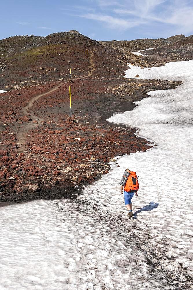Hiker on the Fimmvoerouhals hiking trail, barren volcanic landscape, Porsmoerk Nature Reserve, Suourland, Iceland, Europe