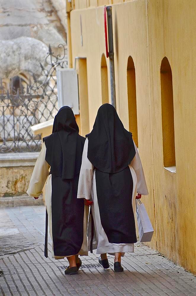 Two nuns go shopping, prayer sisters after shopping, nuns in robe with shopping bags, convent robe, nun's habit