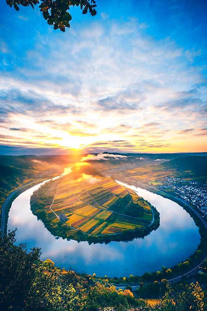 Fantastic view in the morning of the Moselle loop, in autumn, blue sky, sunrise with fog and the village of Bremm at your feet Rhineland-Palatinate, Germany, Europe