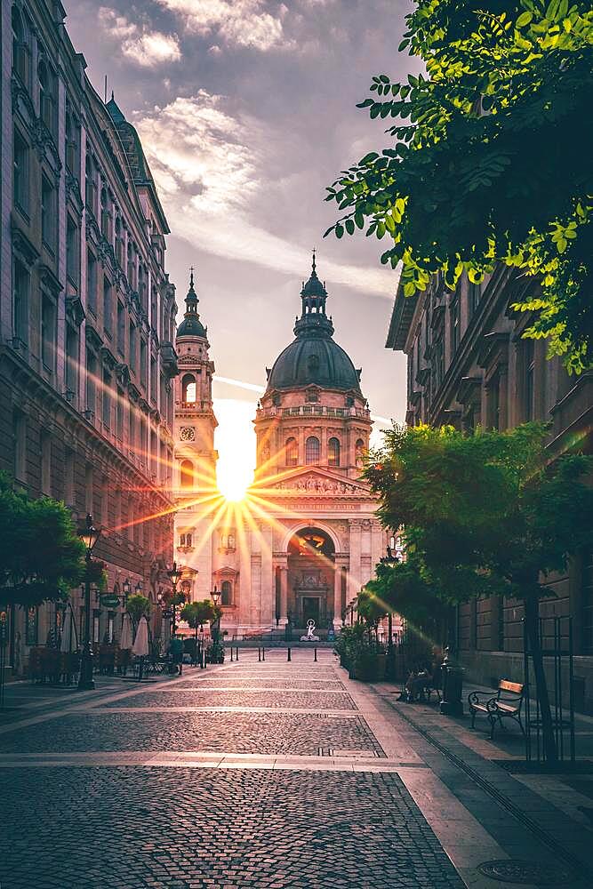 Street view of St. Stephen's Basilica, city view with sun star and sunrise, church, cathedral, Budapest, Hungary, Europe