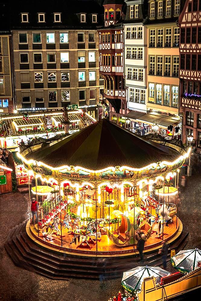 Frankfurt Christmas market, with large historical carousel on the Roemer, with its half-timbered houses photographed from above, blue hour in the evening with lighting, Hesse, Germany, Europe