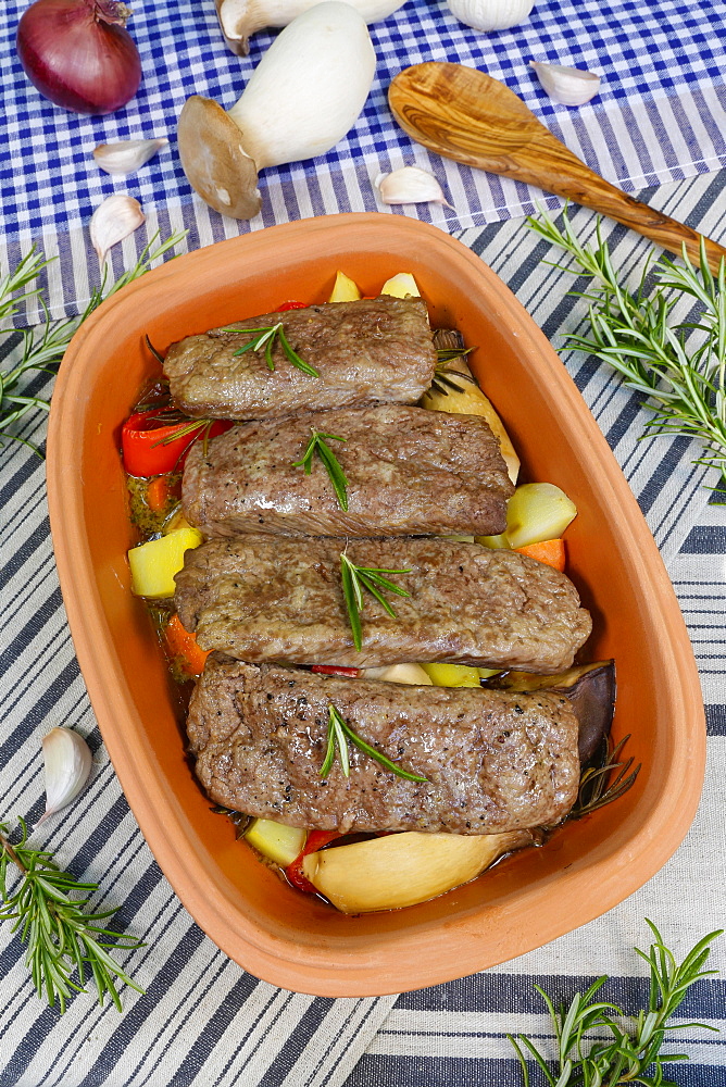 Southern German cuisine, lamb on vegetables from the Roman pot, rosemary, wooden spoon, cooking spoon, mushroom, herb mushroom, Germany, Europe