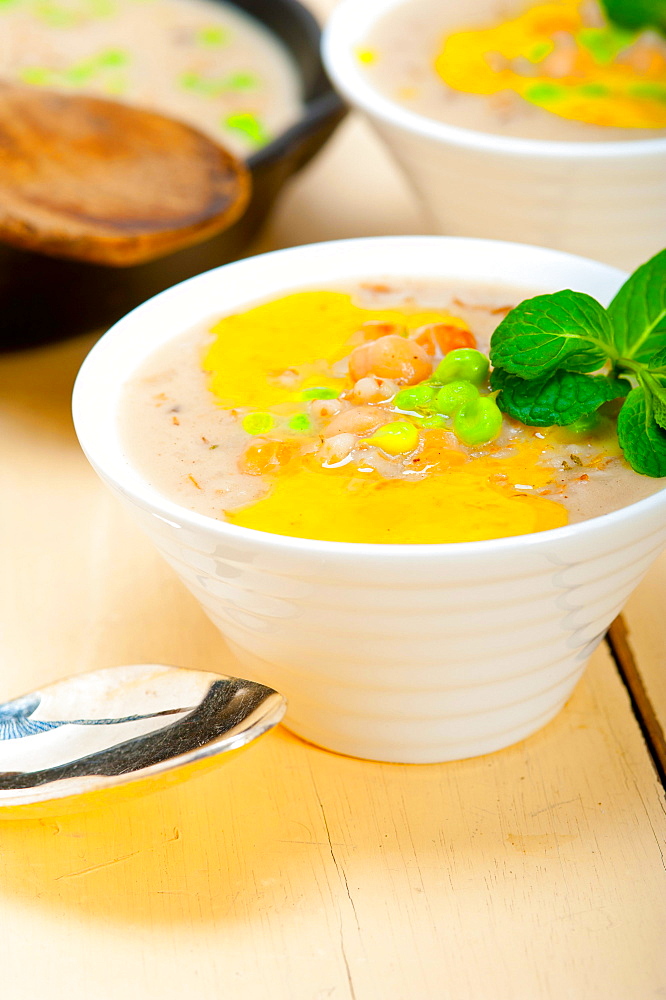 Savoury Middle Eastern Chickpea and Barley Soup with mint leaves on top