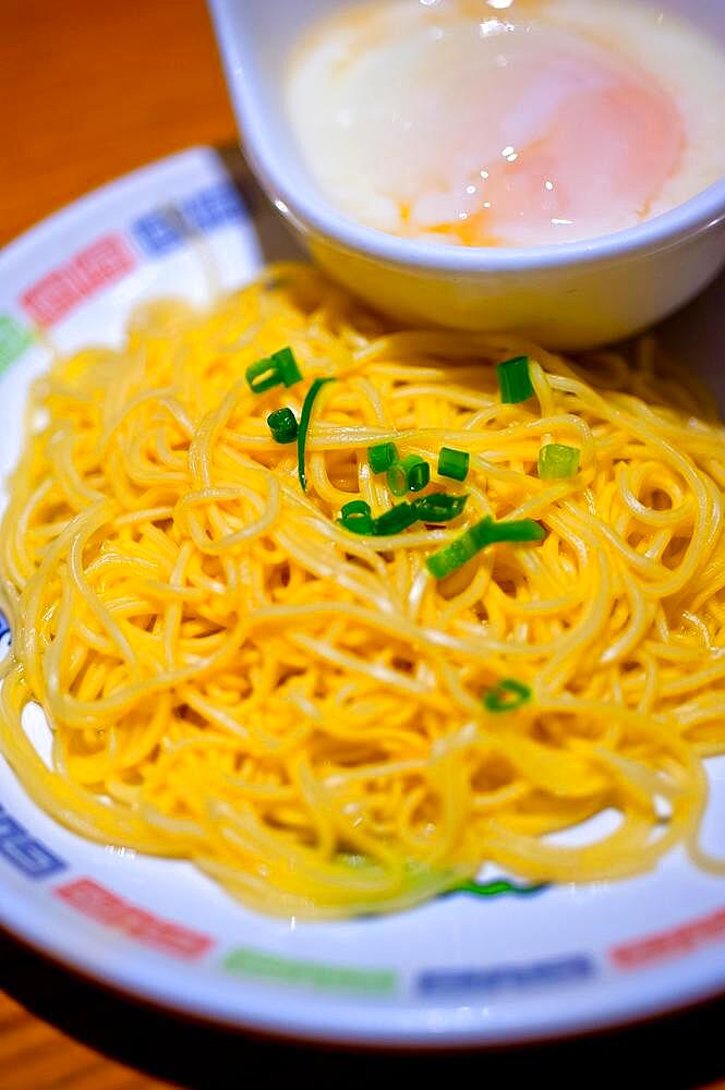 Traditional Japanese ramen noodles with poached egg on the side