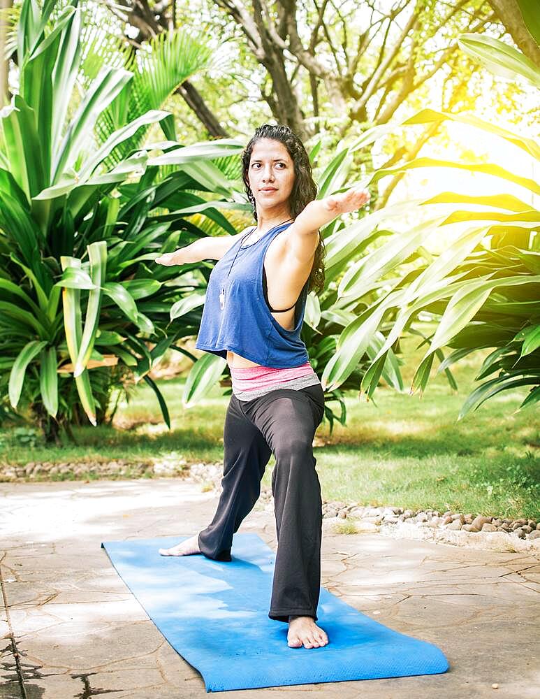 A girl doing flexibility yoga, Woman doing yoga outdoors, young girl showing yoga styles outdoors, yoga and fitness concept