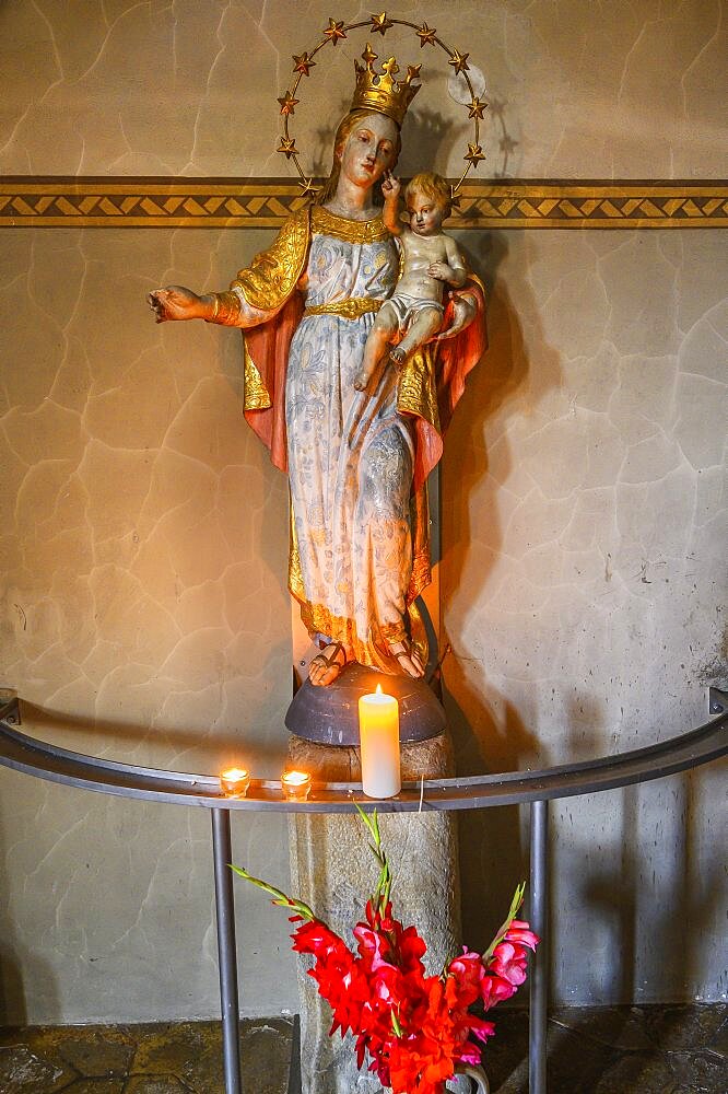 Figure of Mary with crown, infant Jesus and sacrificial candles, Church of St. Martin in Blaichach, Allgaeu, Bavaria, Germany, Europe