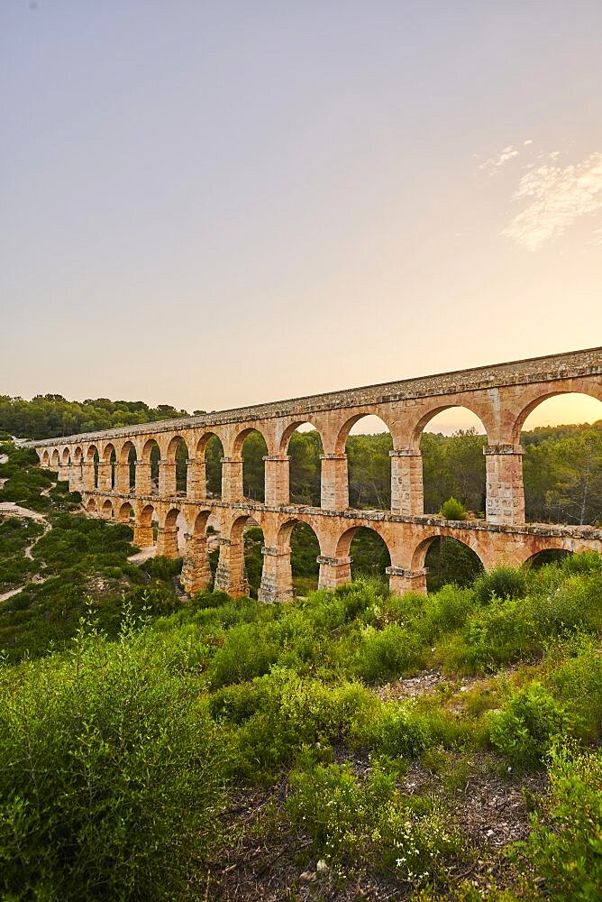 Old roman aqueduct at sunrise, Aqueeducte de les Ferreres, Devil's Bridge, Pont del Diable, Catalonia, Spain, Europe