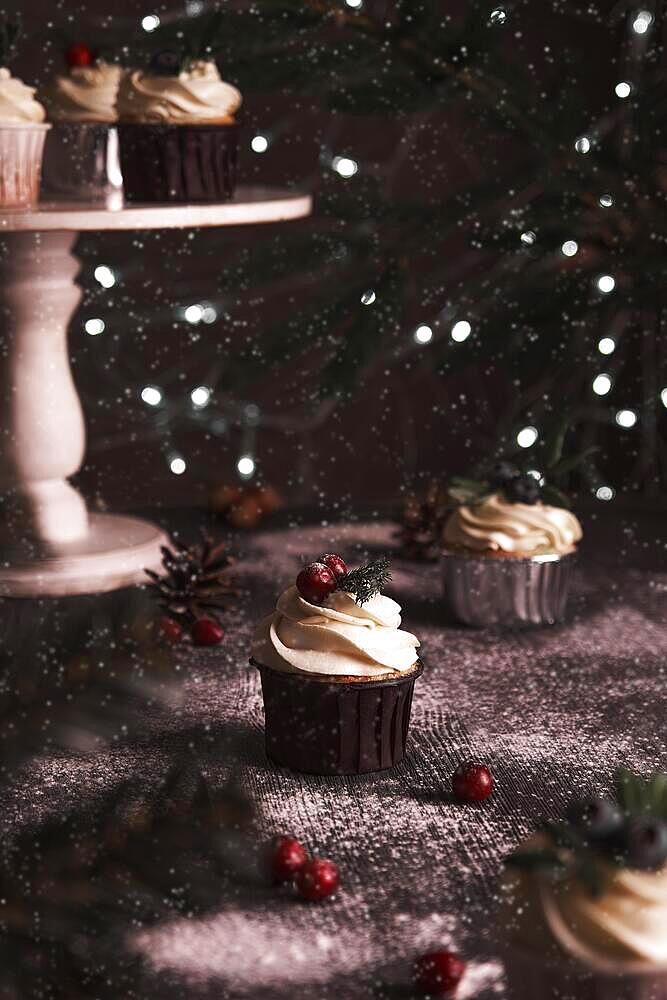 Christmas cakes on wooden background with new year garlands