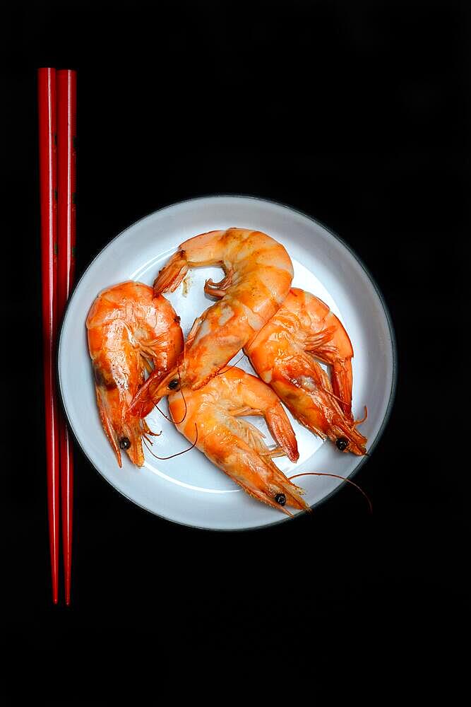 Cooked prawns on plate with chopsticks, prawns, shrimps