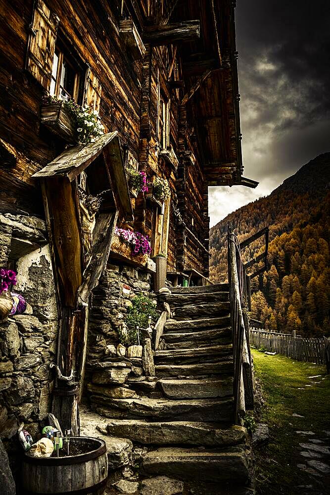 Alpine hut in autumnal mountain landscape with threatening cloudy sky, Pfossental, Merano, Vinschgau, South Tyrol, Italy, Europe