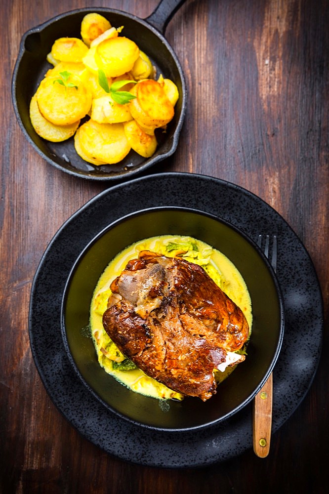 Roaster Pork Knuckle with savoy cabbage and baked potatoes - Traditional German cuisine, Eisbein, Schweinehaxe