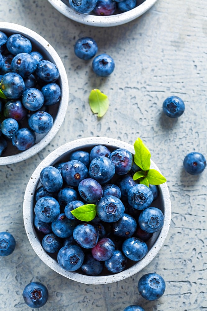 Fresh organic blueberries on stone background