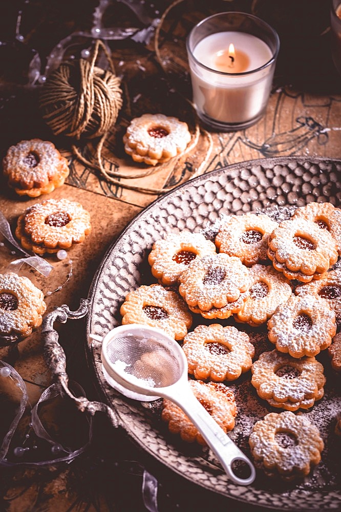 Homemade Christmas cookies with candles in white vintage style