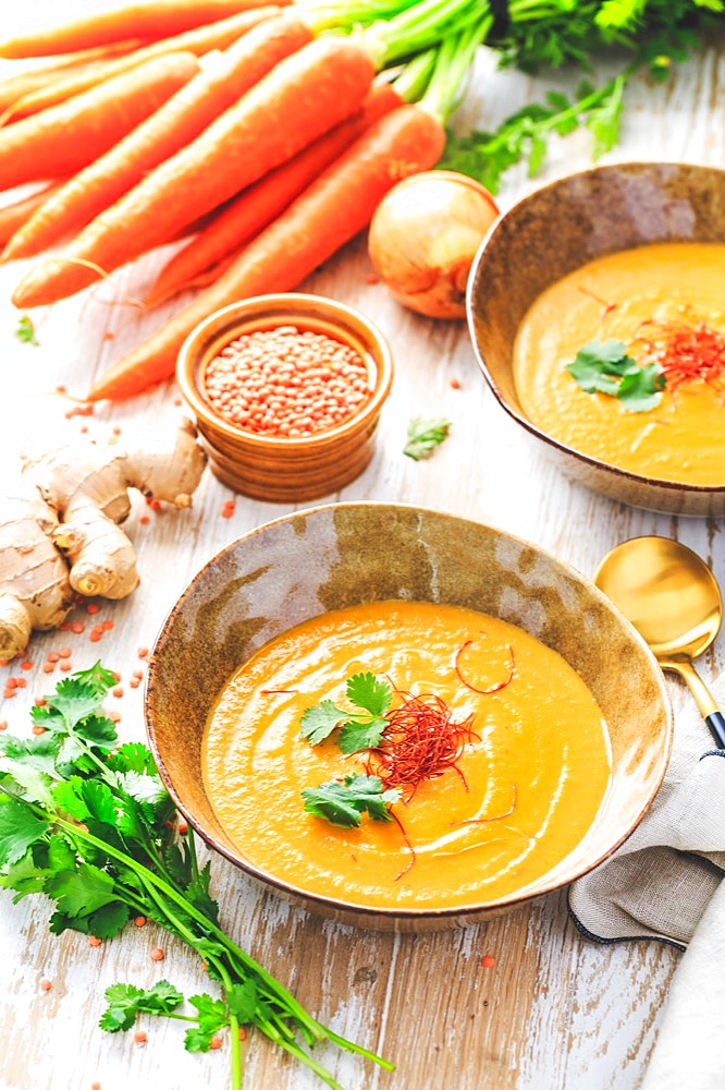 Homemade red lentil soup with carrots, ginger and coconut milk with ingredients