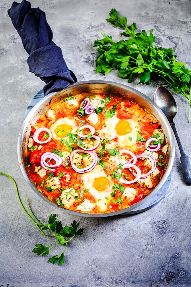 Shakshouka - poached eggs in sauce of tomatoes, peppers, onion and feta cheese. Keto meal and low carb