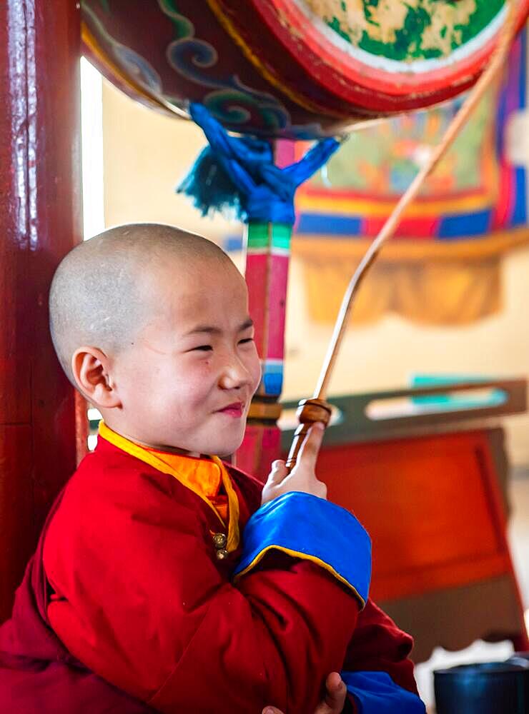 Happy young lama in Buddhist temple. Mongolia, Mongolia, Asia