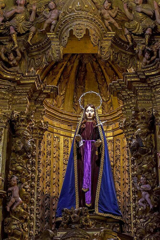 The crying saint. Sculpture in 18th century Brazilian Baroque sacred art surrounded by angels and present in the interior of the rich churches of Ouro Preto in Minas Gerais, Brasil