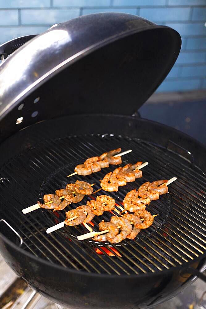 Grilled shrimps on the flaming grill at outdoors summer party