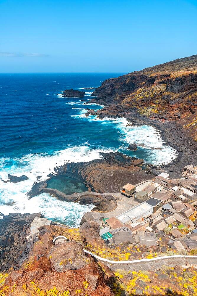 View from above of the fishing village of Pozo de las Calcosas on the island of El Hierro and the cliffs. Canary Islands, municipality of Valverde